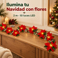 Guirnalda LED de flores de Pascua sobre un mueble de madera